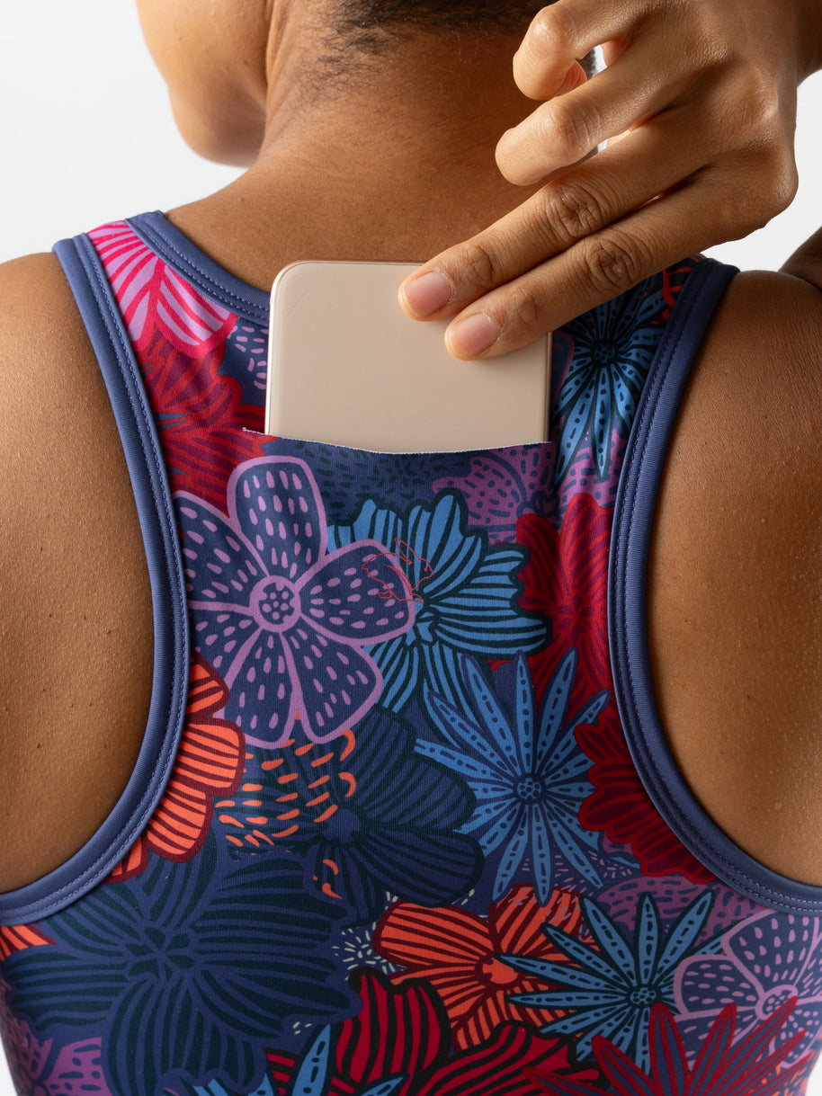 Utili Bra-Vo by Rabbit in multicolor floral, multifunctional sports bra with laser-cut back pocket for secure phone storage during running