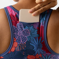 Utili Bra-Vo by Rabbit in multicolor floral, multifunctional sports bra with laser-cut back pocket for secure phone storage during running