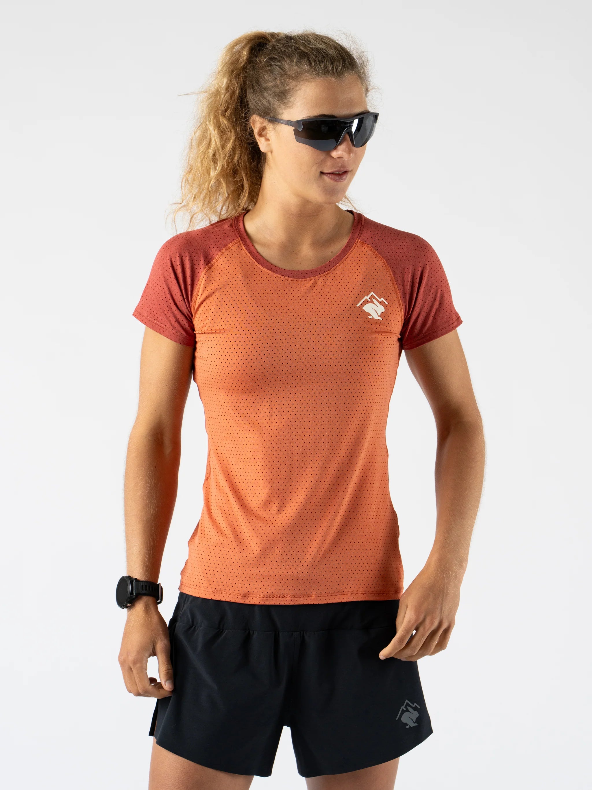 EZ Tee Perf SS Trail - Women by Rabbit in rust and dark red, lightweight breathable trail running top with all-over perforations for comfort