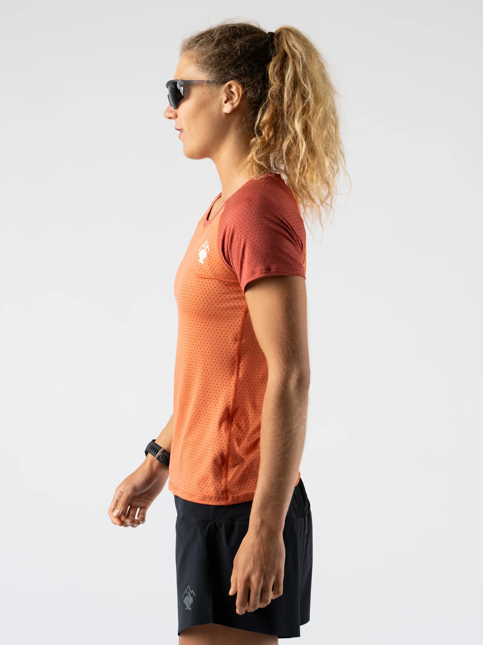 EZ Tee Perf SS Trail - Women by Rabbit in rust orange lightweight breathable perforated running shirt ideal for trail running outdoors