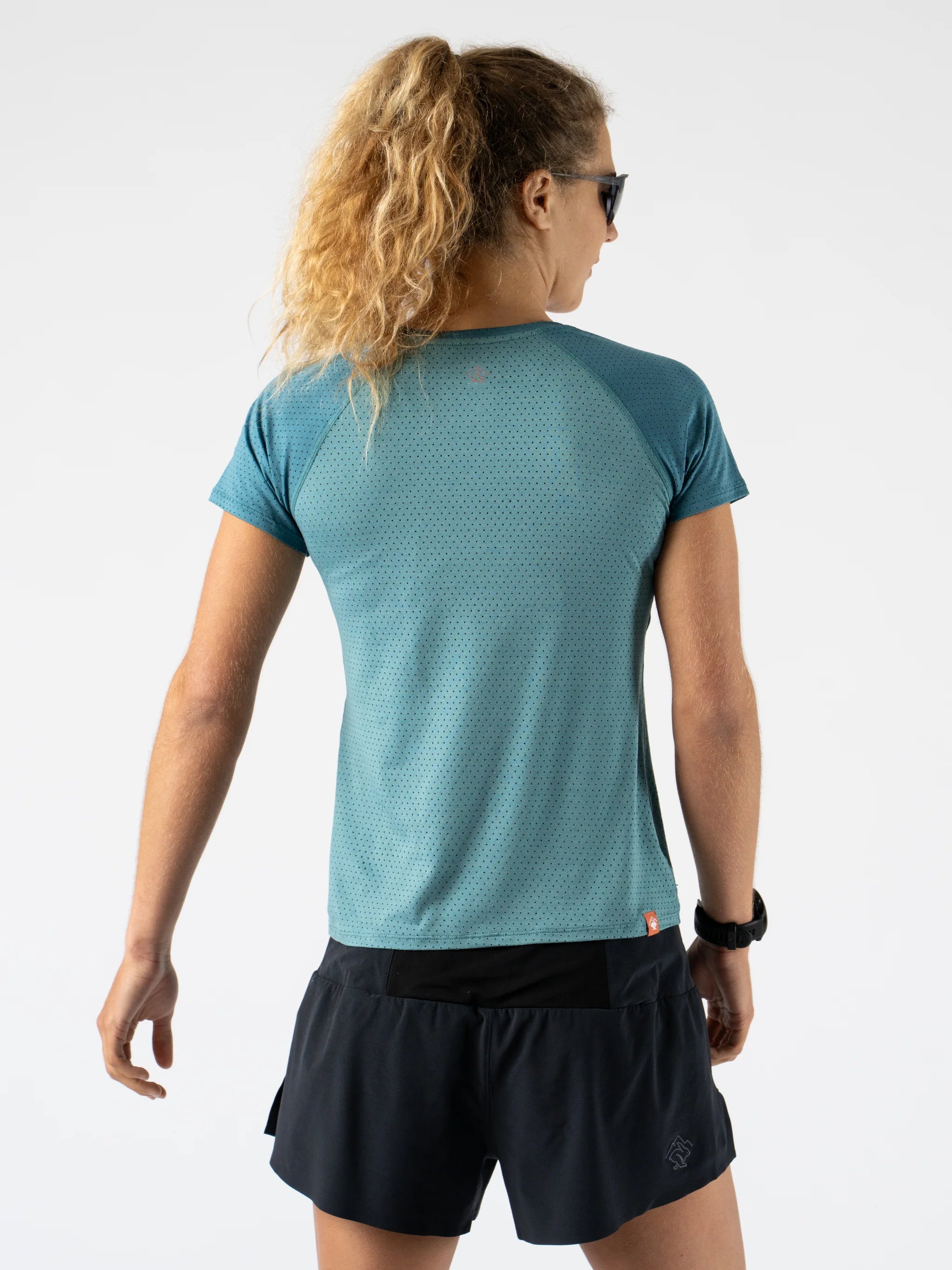 EZ Tee Perf SS Trail - Women by Rabbit in teal, breathable lightweight perforated running top designed for trail running comfort and breathability