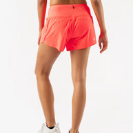 Summit Chasers 4 - Women by Rabbit in bright coral with durable stretch ripstop and five pockets, ideal for running and outdoor activities