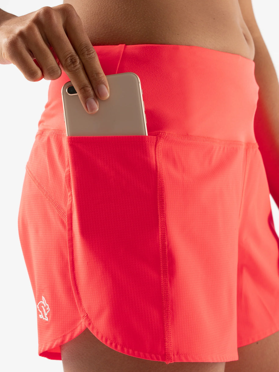 Summit Chasers 4 - Women by Rabbit in bright coral durable stretch diamond ripstop shorts with five pockets including back zip for running and outdoor use