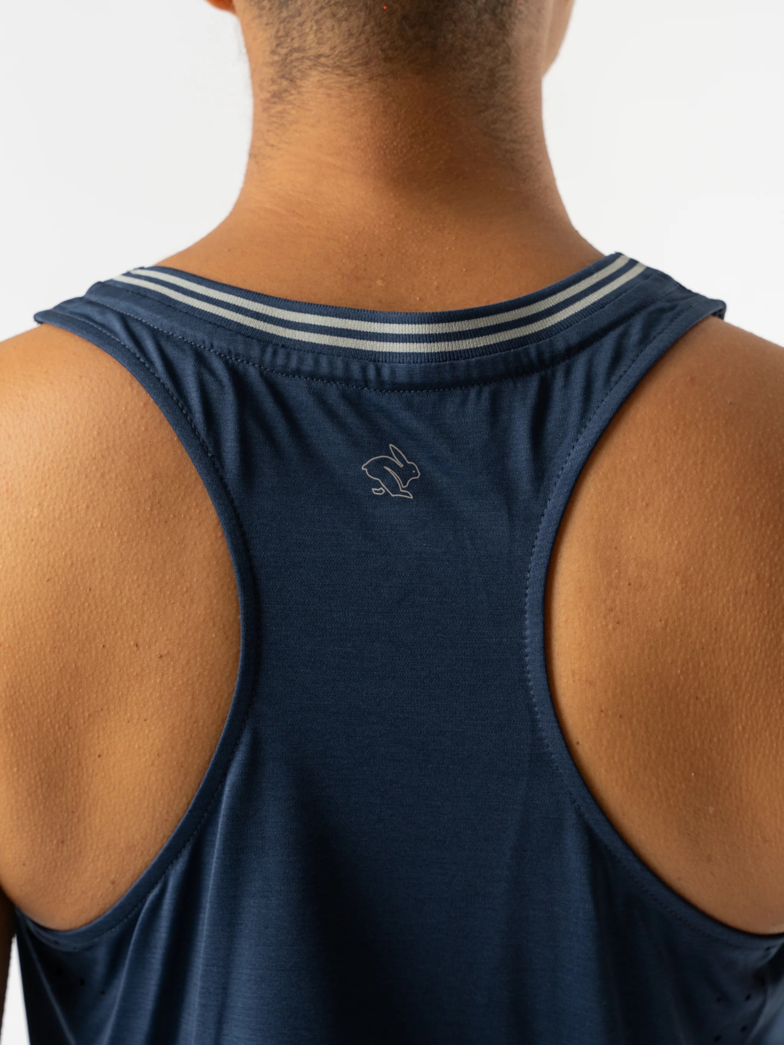 Race Pace Tank - Women by Rabbit in navy blue semi-relaxed tank with breathable laser-cut perfs ideal for running and training