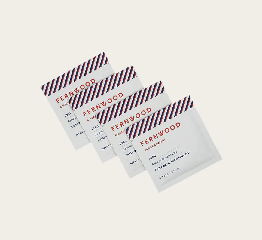 Instant Decaf Coffee by Fernwood in white sachets with red and blue stripes, small-batch brewed crystallized coffee solids from Canada-made brand
