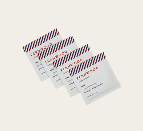 Instant Decaf Coffee by Fernwood in white sachets with red and blue stripes, small-batch brewed crystallized coffee solids from Canada-made brand