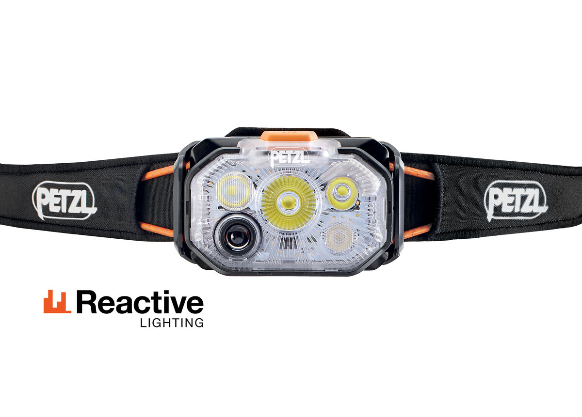 Front close-up of the Petzl Swift RL Headlamp lamp with black Petzl strap and Reactive Lighting logo