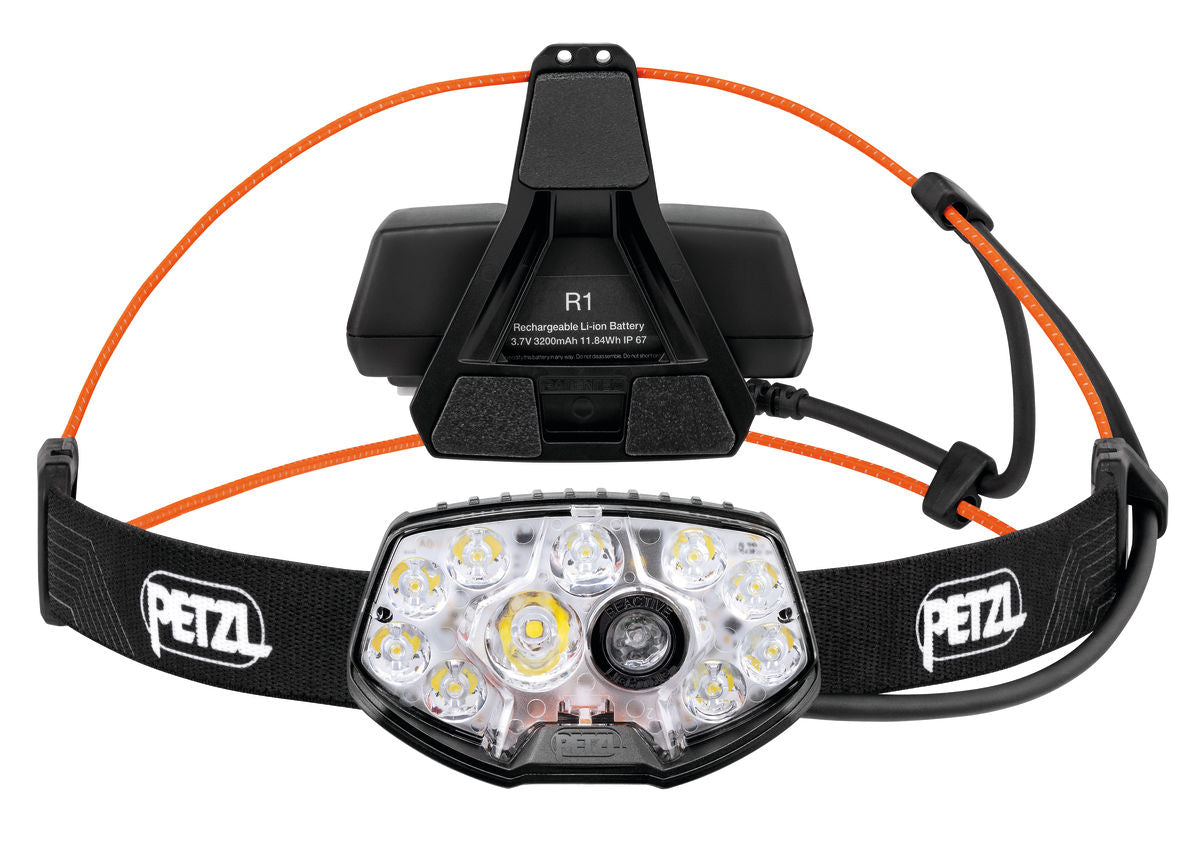 Nao RL Headlamp by Petzl in black with orange accents, 1500 lumens rechargeable trail running headlamp, lightweight and adjustable.