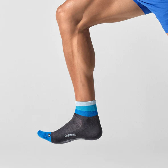 Elite Light Cushion Quarter by Feetures in black and blue with anatomical design and targeted comp for running and active use