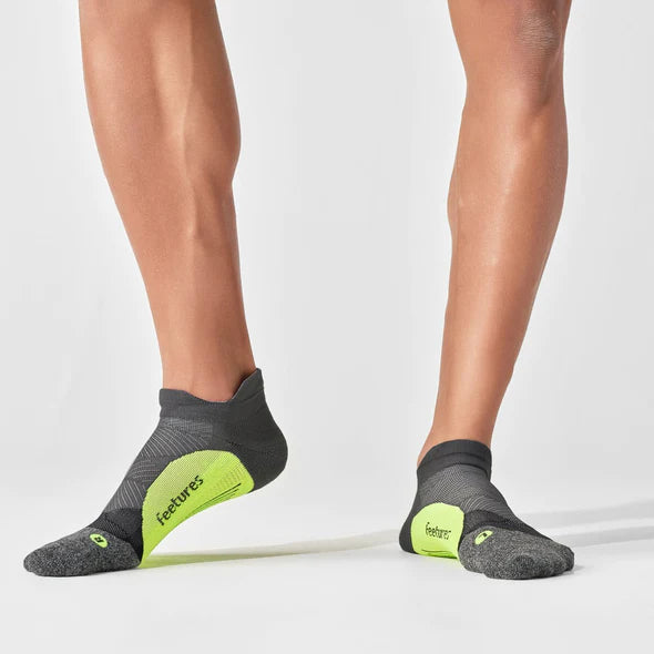 Elite Light Cushion No Show Tab by Feetures in grey and neon yellow, lightweight anatomical running socks with targeted compression for enhanced performance