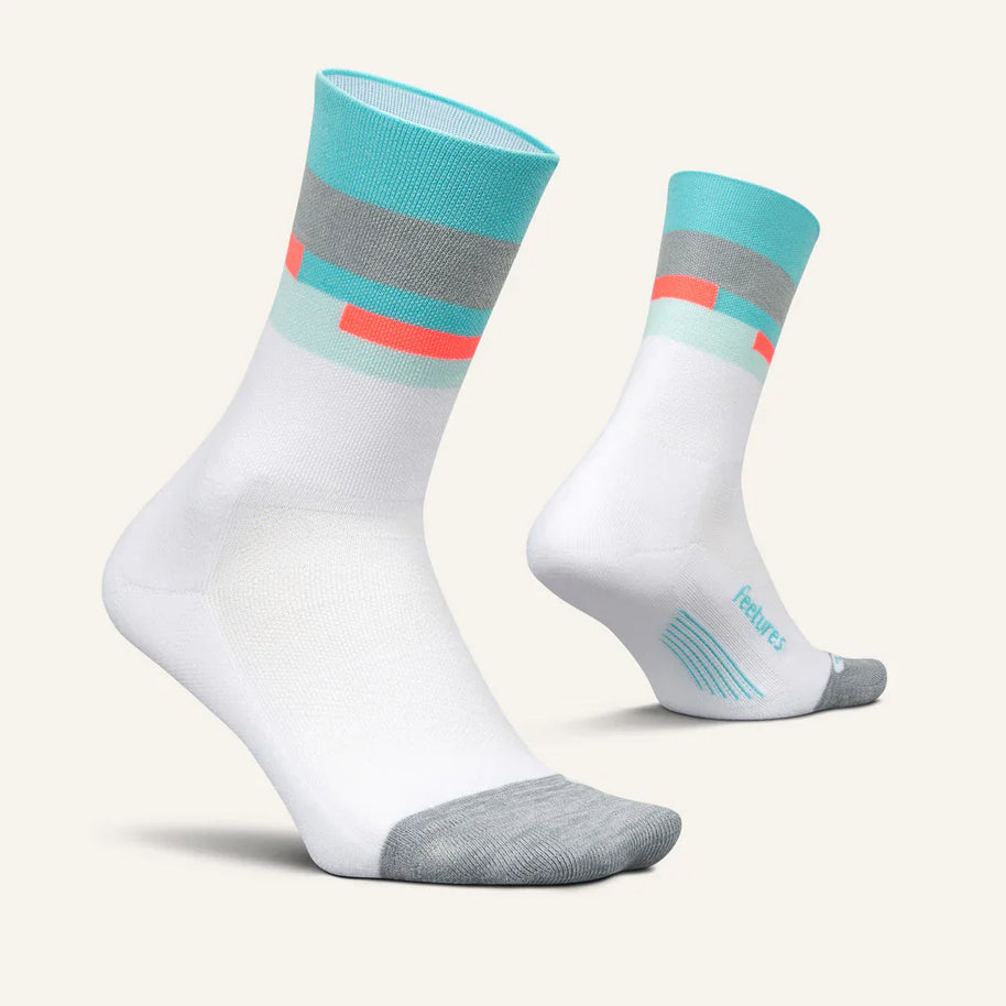Elite Light Cushion Mini-Crew by Feetures in white, grey, and teal with targeted compression and light cushioning for running comfort and blister prevention