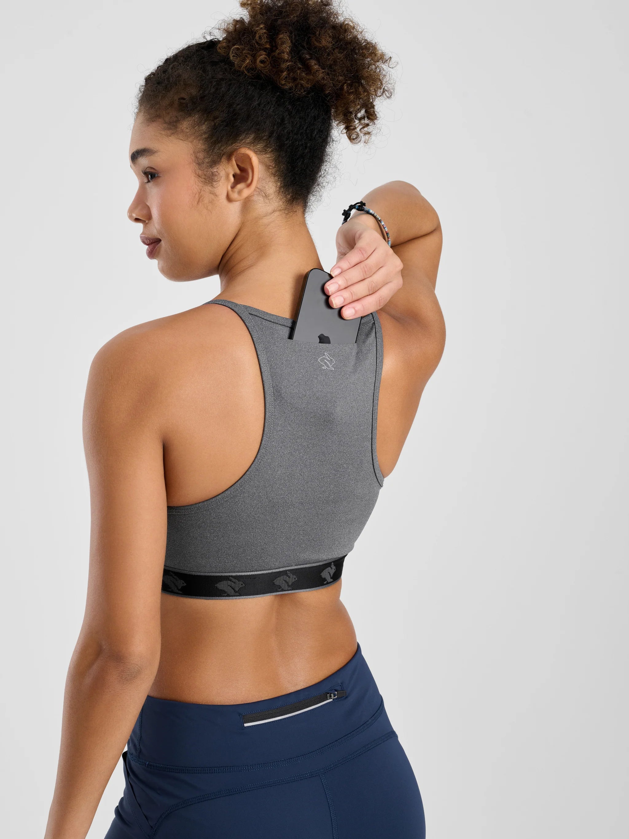 Strappy Pocket Bra - Women by Rabbit in dark grey with built-in pocket, minimal bounce, and total comfort for activewear use