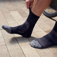 Elite Ultra Light Cushion Quarter - 2023 by Feetures in black and grey with anatomical design, targeted compression, and ultra light cushioning for running.