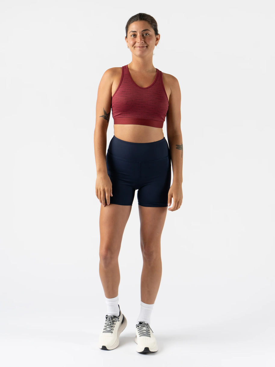 Utili Bra-Vo by Rabbit in red multifunctional sports bra with laser-cut pocket for essentials, minimizing bounce for running and training