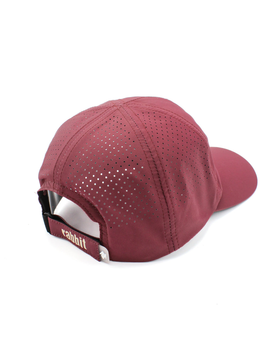 Elite Hat by Rabbit in burgundy with laser-cut vents, lightweight moisture-wicking cap with baseball-style bill for sun and gear protection