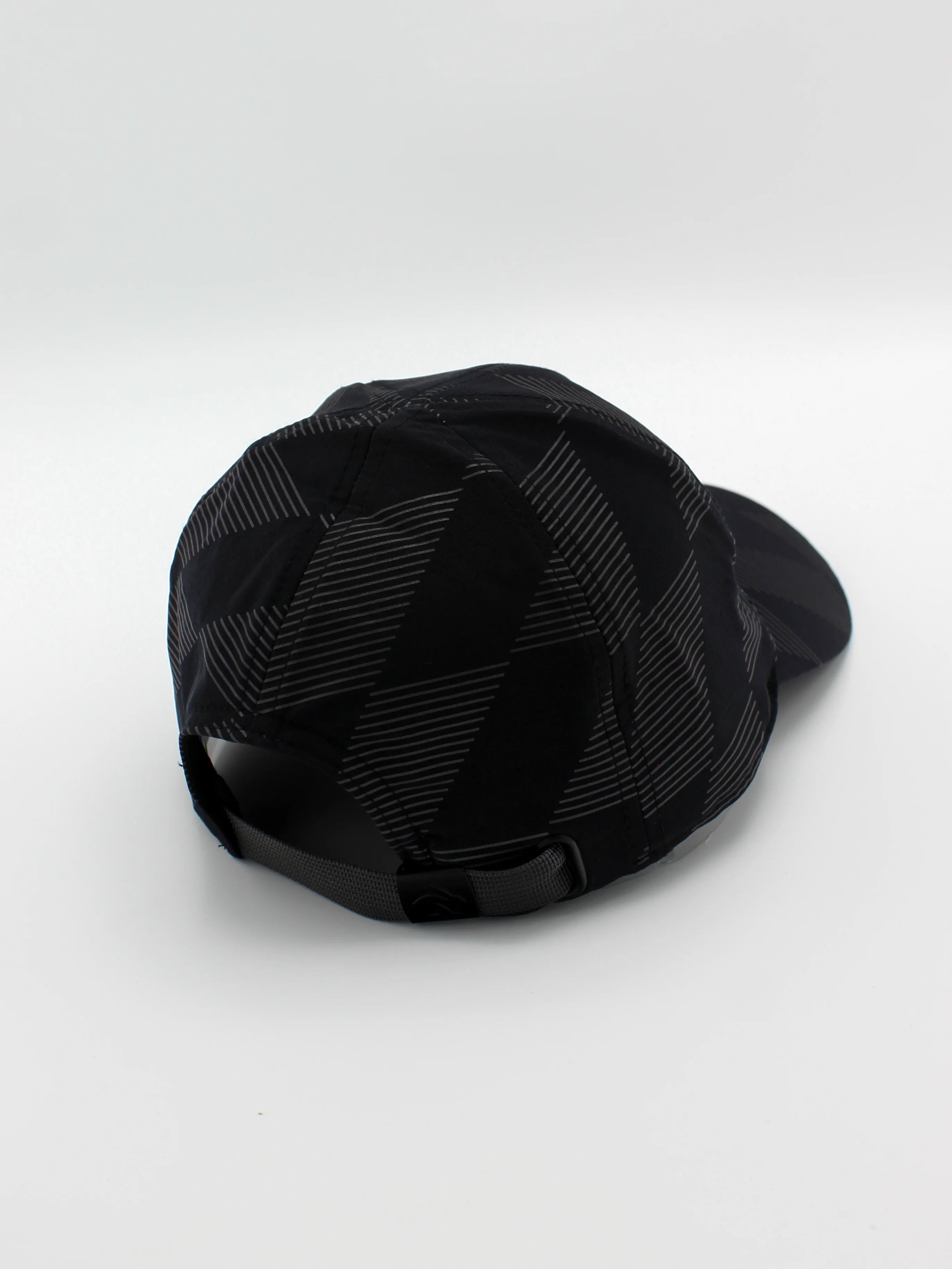Low Light Tech Cap by Rabbit in black with reflective geometric pattern, adjustable fit, designed for visibility in low light running and outdoor use