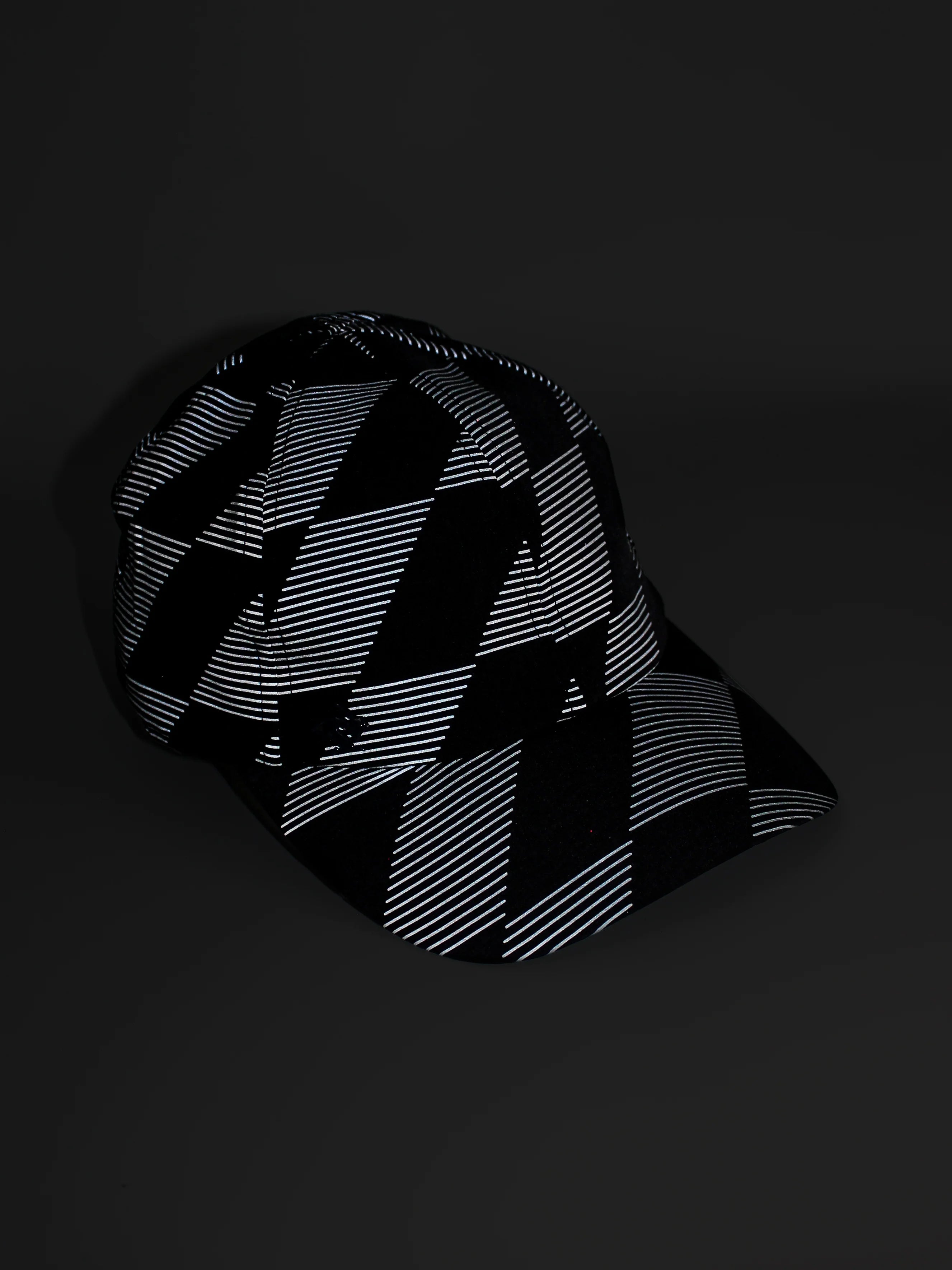 Low Light Tech Cap by Rabbit in black with reflective geometric pattern, designed for visibility and safety in low light conditions