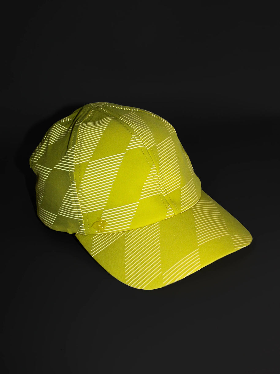 Low Light Tech Cap by Rabbit in yellow and white with reflective pattern, designed for visibility and safety in low light conditions