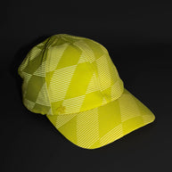 Low Light Tech Cap by Rabbit in yellow and white with reflective pattern, designed for visibility and safety in low light conditions