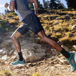 Ultraventure 4 - Men by Topo Athletic in teal and orange lightweight trail running shoe with plush platform for rugged outdoor use