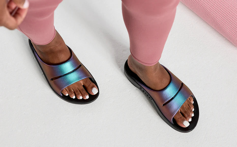 OOahh Luxe - Women by Oofos in iridescent blue and purple slides with agile OOfoam strap for support and comfort in casual wear