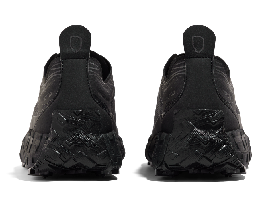 001 Core - Women by Norda in black lightweight trail shoe with seamless Bio-Dyneema upper and Vibram sole for rugged outdoor use