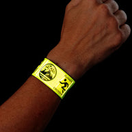 Nathan Reflex Bands in Hi Viz Yellow on a wrist against a black background