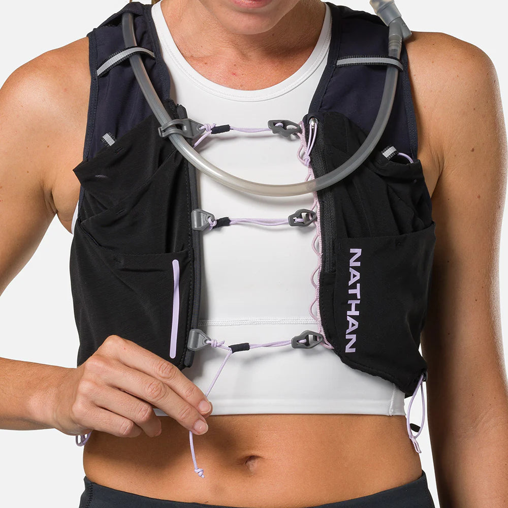 Pinnacle Pro 12L - Women by Nathan in black and purple with slider sternum cords and Quick-Fit system for running comfort and fit adjustment