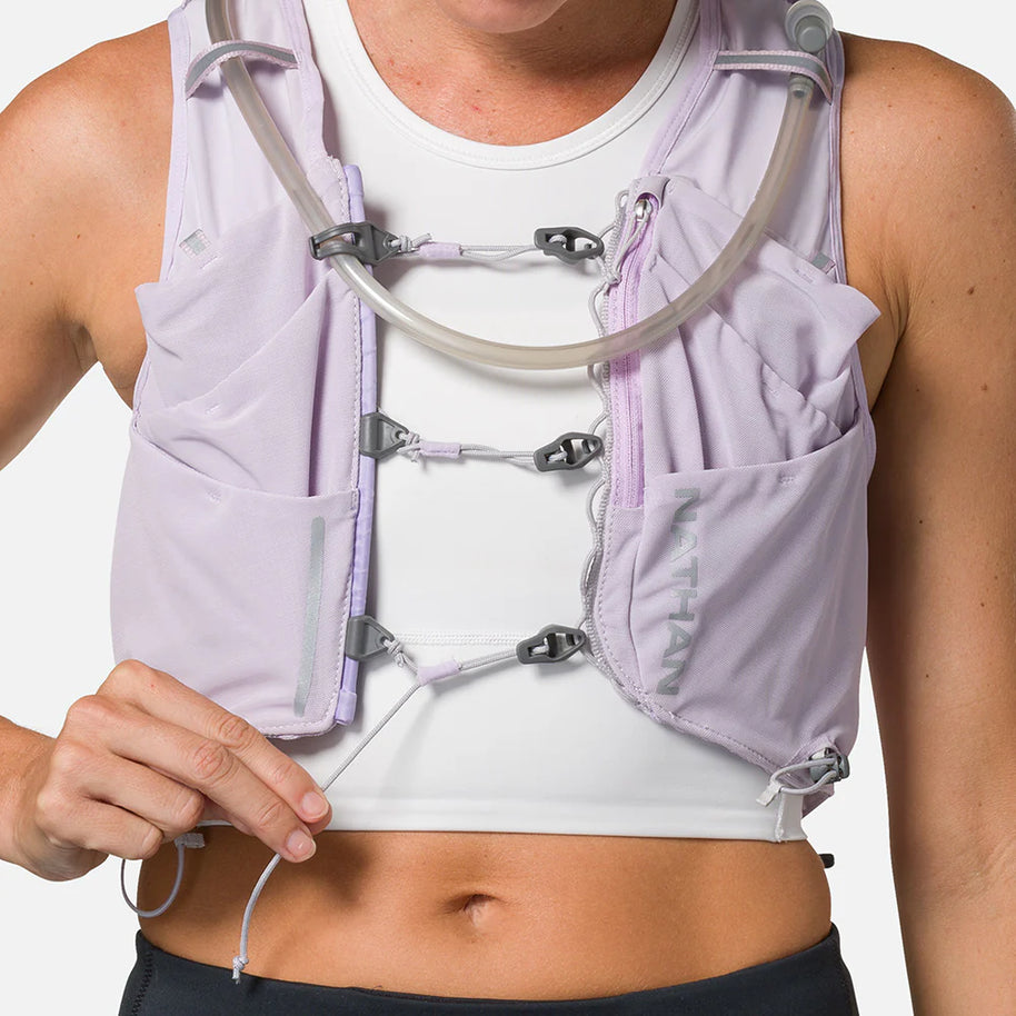 Pinnacle Pro 12L - Women by Nathan in light purple with slider sternum cords and Quick-Fit adjustment for running hydration and comfort