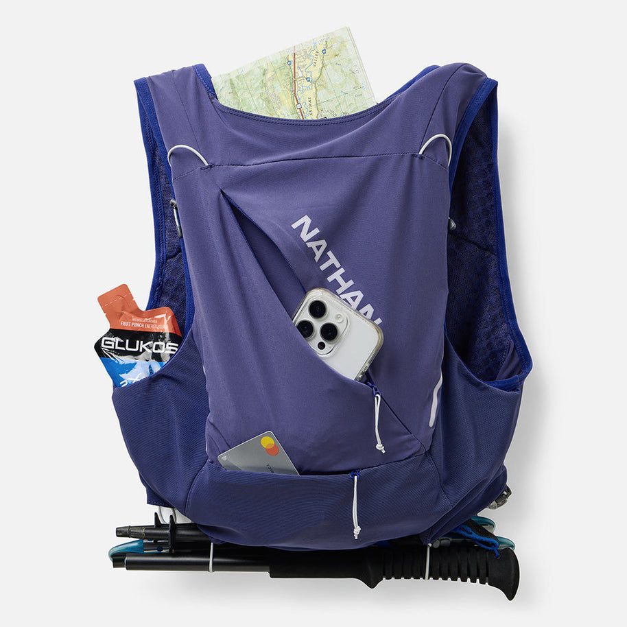 Nathan Pinnacle Pro 12L women's vest in Indigo/Light Blue, back pocket holding a map, phone and poles