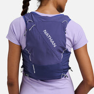Woman wearing the Nathan Pinnacle Pro 12L running vest in Indigo/Light Blue, back view