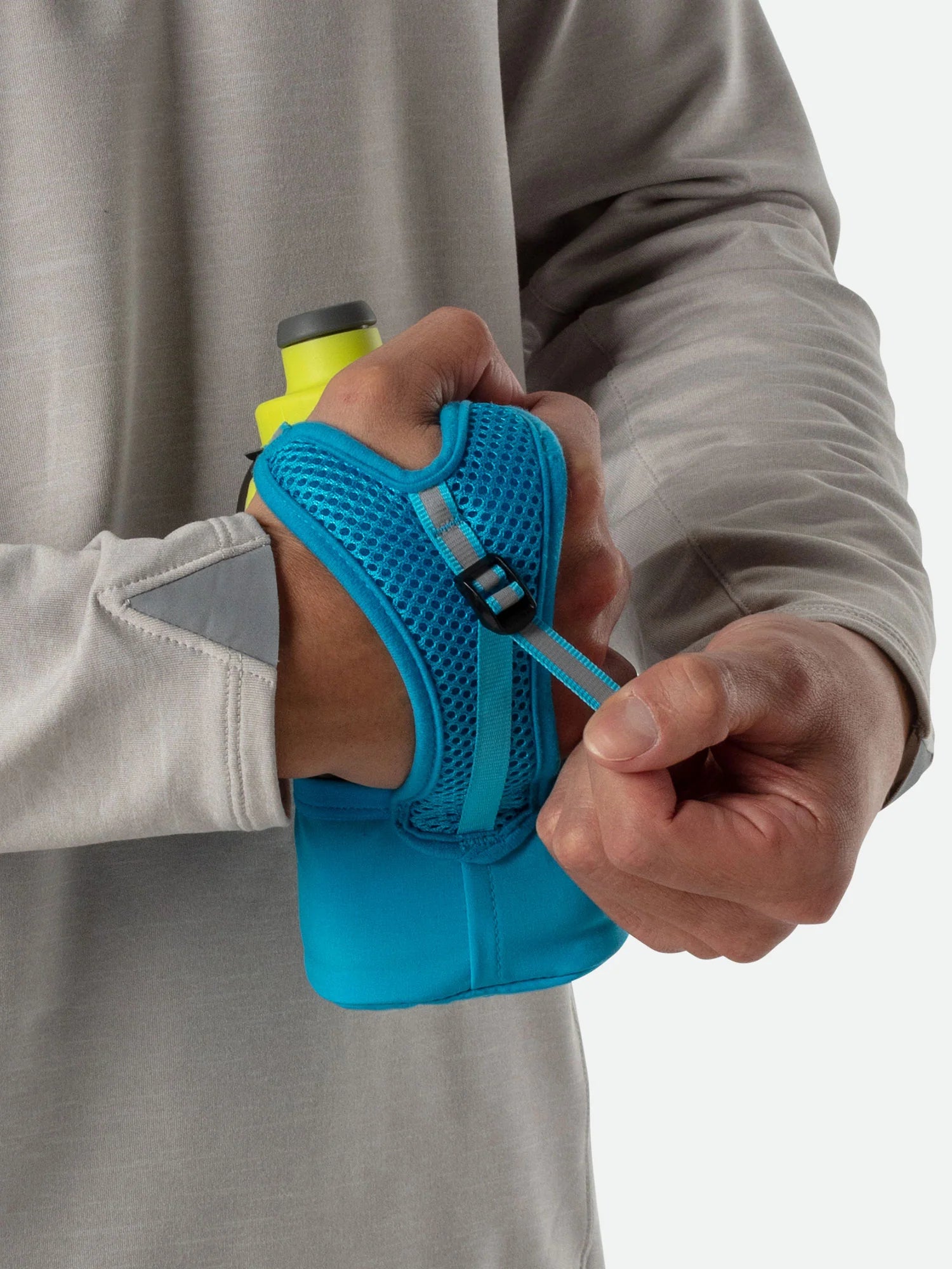 Quick Squeeze Lite 12oz Handheld by Nathan in lime green and blue with adjustable strap, lightweight grip, no-slip insert for running hydration