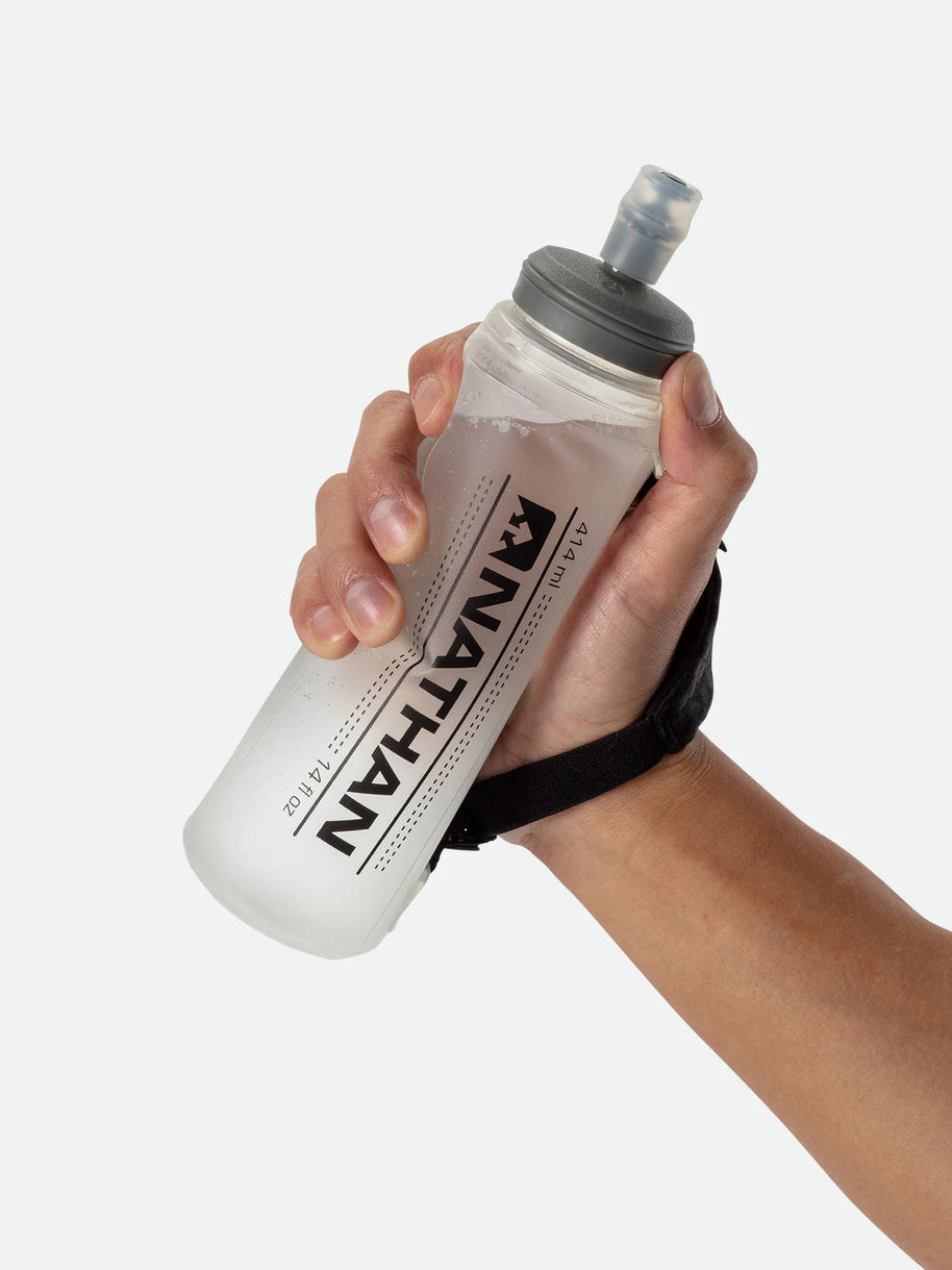ExoShot Lite 14oz Handheld by Nathan in translucent white with black strap, soft flask with integrated hand strap and rigid ExoSpine for running