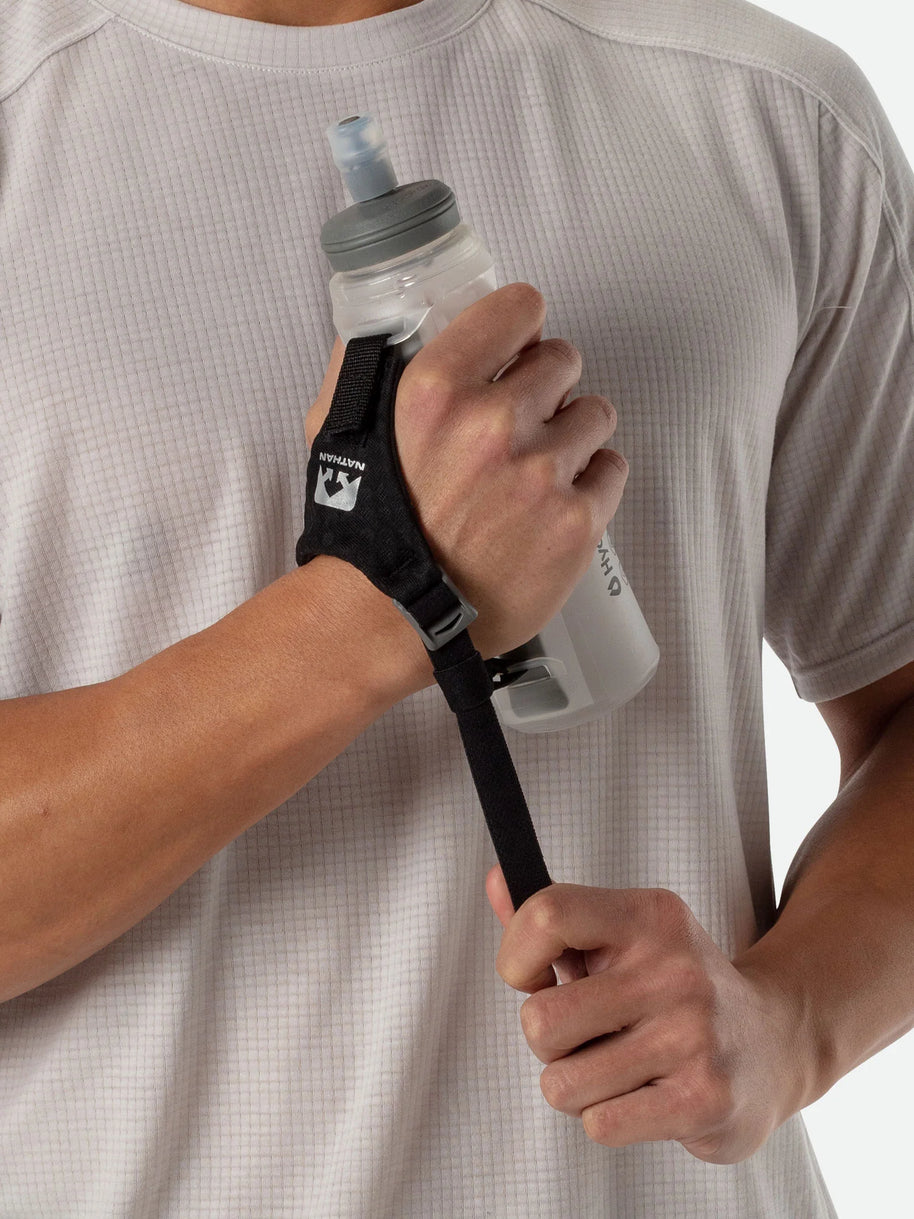 ExoShot Lite 14oz Handheld by Nathan in translucent grey with black strap, lightweight soft flask with rigid ExoSpine for comfort and running efficiency