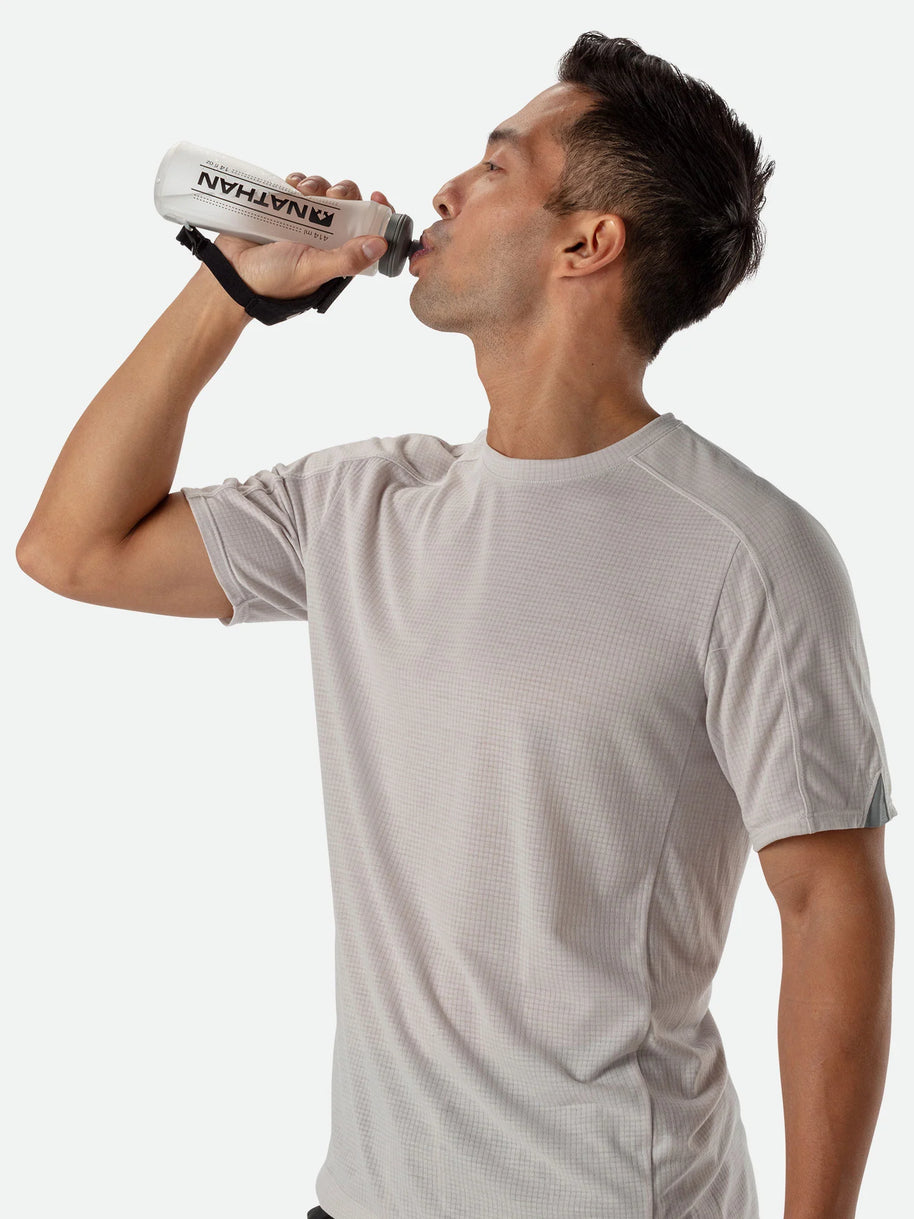 ExoShot Lite 14oz Handheld by Nathan in clear with black strap, soft flask with rigid ExoSpine for comfort and efficient hydration during running
