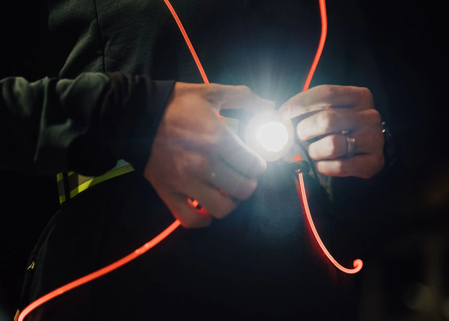 Rechargeble LED Safety Vest by NiteVest in black with red trim, featuring 150 lumen chest light and 360-degree illumination for safety