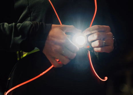 Rechargeble LED Safety Vest by NiteVest in black with red trim, featuring 150 lumen chest light and 360-degree illumination for safety