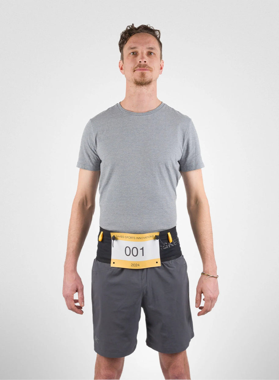 Running Band by Naked in black and yellow, high-performance waist belt for carrying fuel, fluids, accessories, ideal for running and trekking.