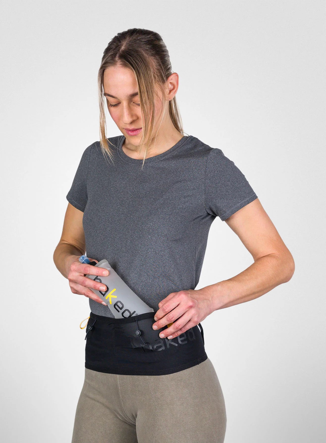 Running Band by Naked in black waist belt design, high-performance for carrying fuel, fluids, or trekking poles during running and outdoor use