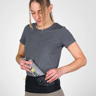 Running Band by Naked in black waist belt design, high-performance for carrying fuel, fluids, or trekking poles during running and outdoor use