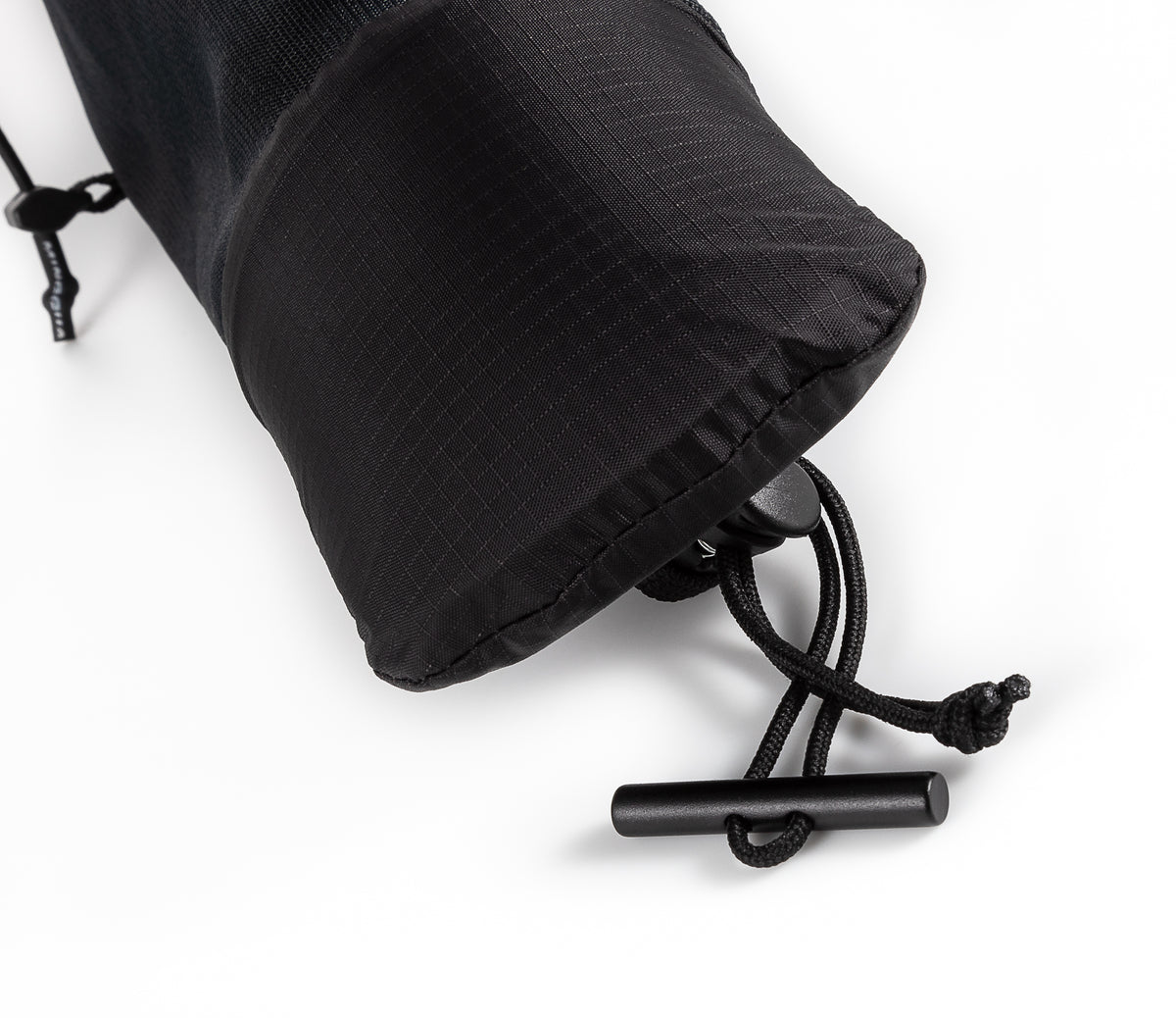 Close-up of the drawcord and toggle closing the base of the UltrAspire Pole Quiver in Black