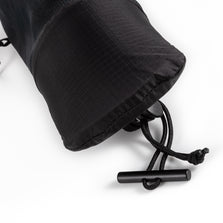 Close-up of the drawcord and toggle closing the base of the UltrAspire Pole Quiver in Black