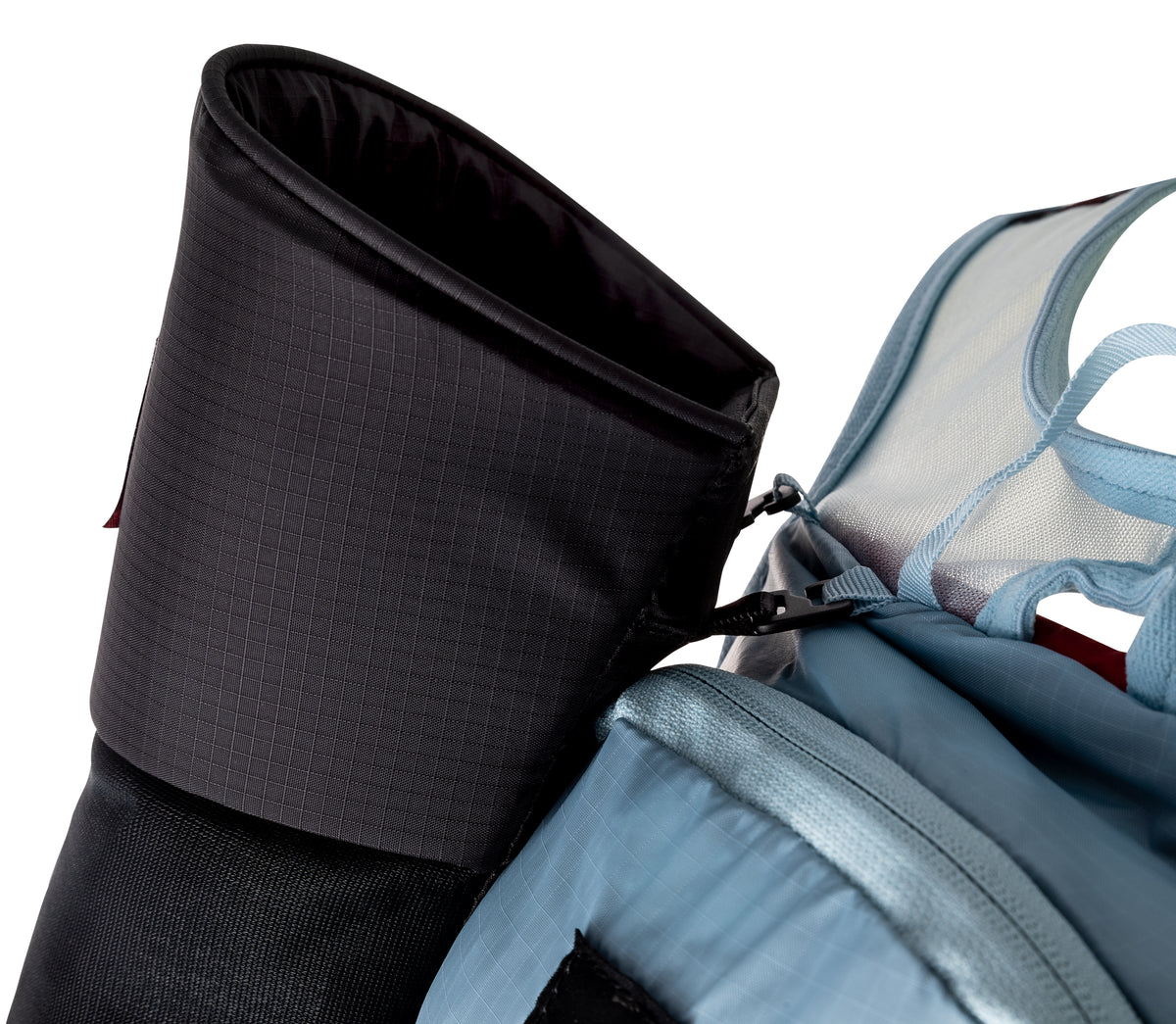 Close-up of the padded top opening of the UltrAspire Pole Quiver in Black mounted beside a running vest