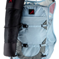 UltrAspire Pole Quiver in Black attached to the side of a light blue running vest