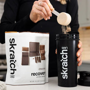 Sport Recovery Drink Mix chocolate by Skratch Labs in white bag with chocolate pieces, nutrition for rapid refuel and rehydrate