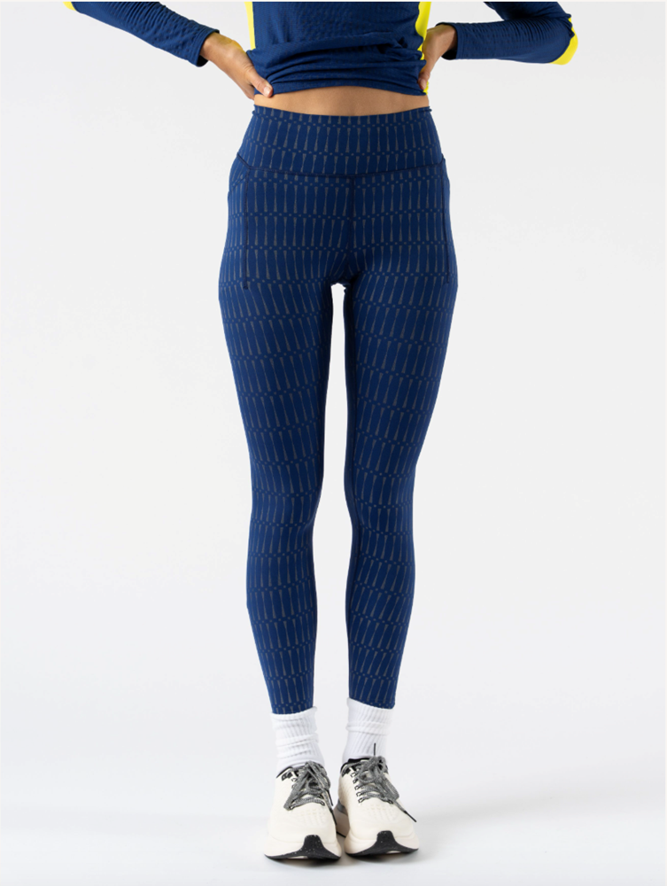 Low Light Speed Tights - Women by Rabbit in navy with 360° reflective print, compressive fit, laser-cut perfs, and five pockets for running safety and comfort