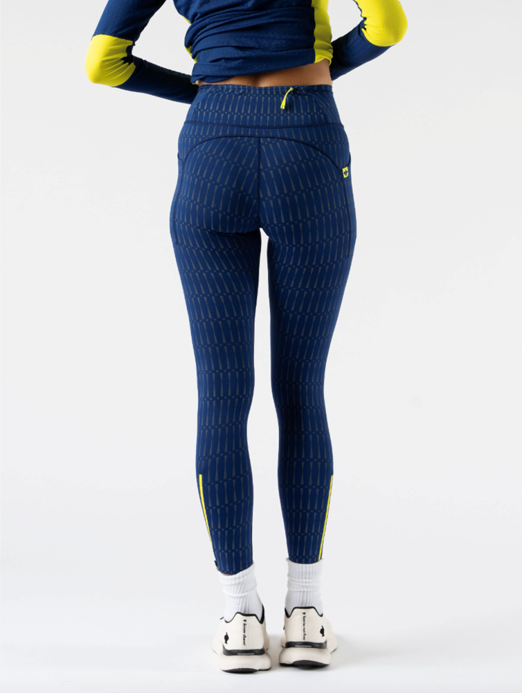 Low Light Speed Tights - Women by Rabbit in navy with 360° reflective print, compressive fit, laser-cut perfs, and five pockets for safe running