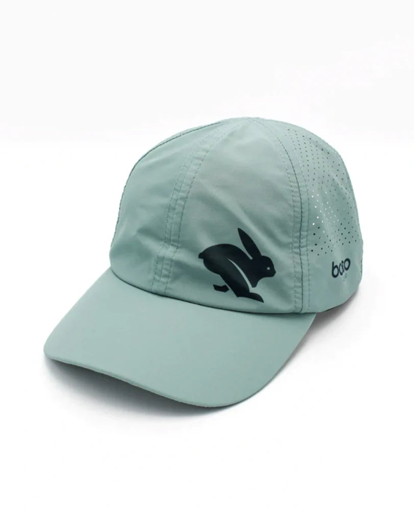 Elite Hat by Rabbit in moonlight blue with baseball cap bill, laser-cut vents, lightweight wicking fabric for sun and gear protection.
