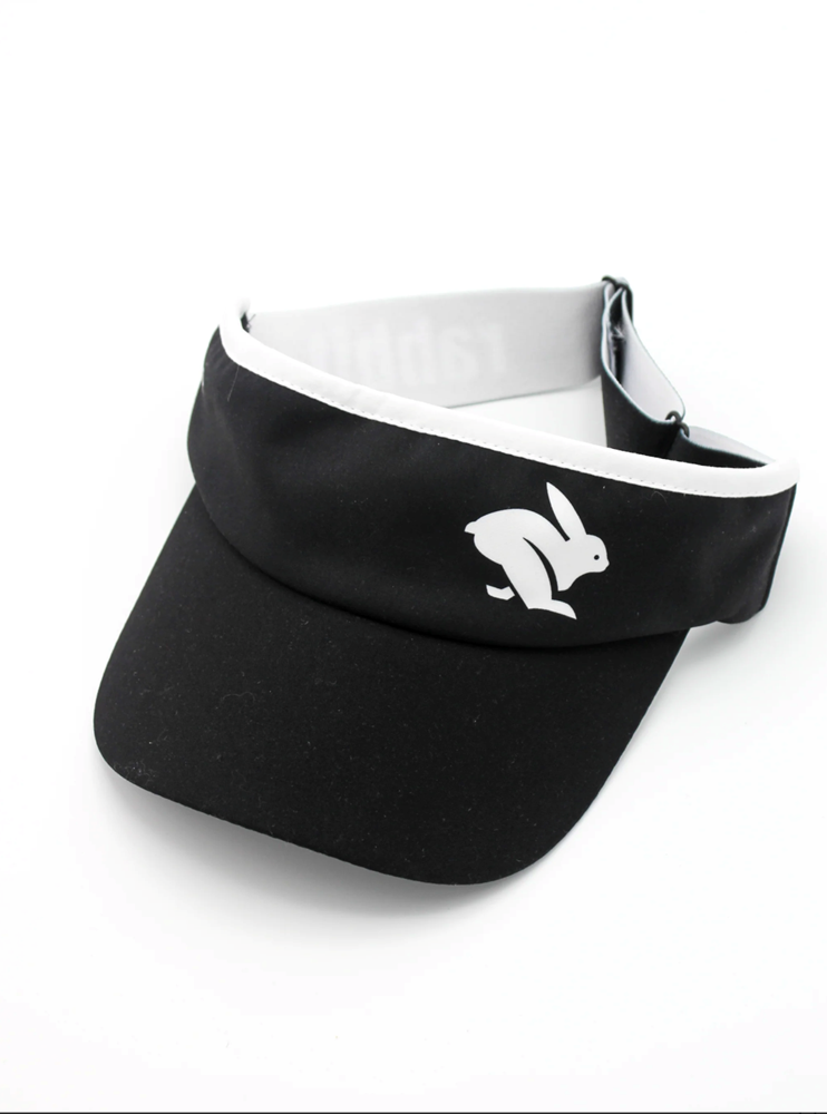 Visor by Rabbit in black and white, lightweight moisture-wicking fabric with inner sweatband, ideal for running and outdoor use