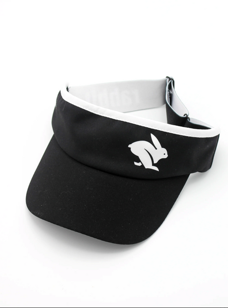 Visor by Rabbit in black and white, lightweight moisture-wicking fabric with inner sweatband, ideal for running and outdoor use
